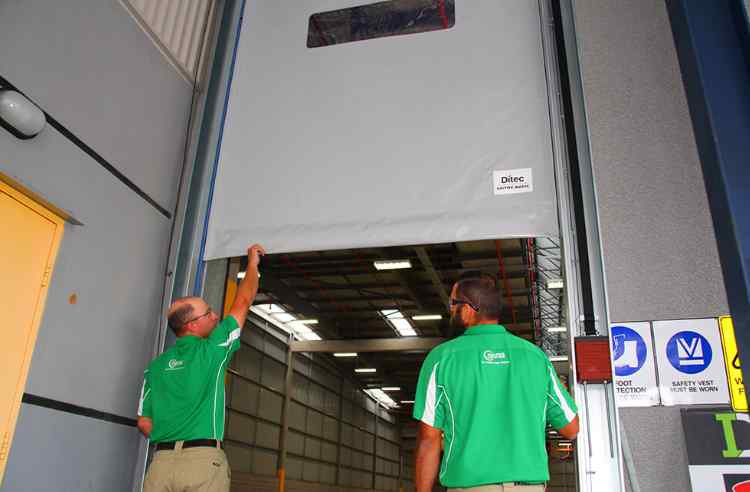 Rapid Automatic technicians working on the installation of a high speed door.